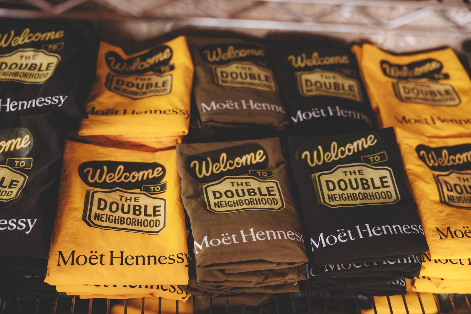 Folded printed swag reading Welcome to The Double Neighborhood with Moët Hennessy branding