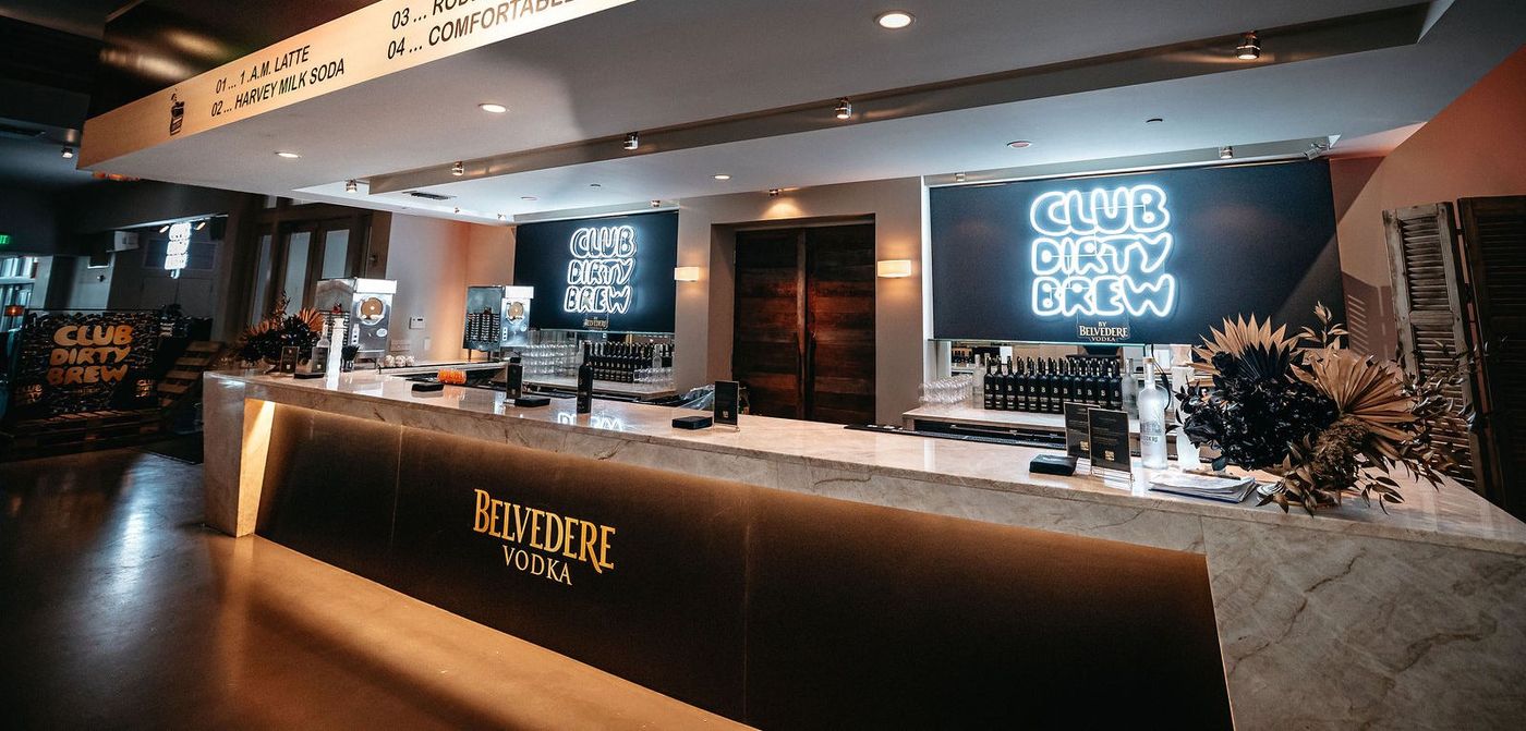 The long Belvedere bar with its menu strip and the neon sign behind